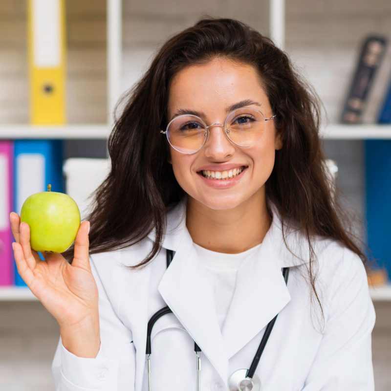 front-view-smiley-doctor-with-apple